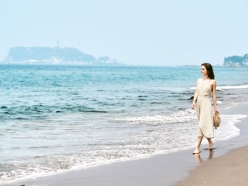 A Person Walking On A Beach